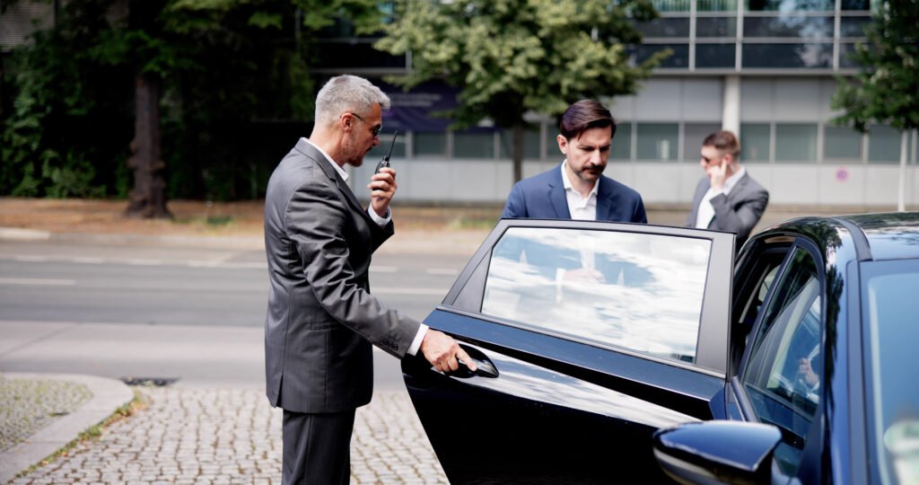 Corporate Bodyguards assure a safe exit for businessman in luxury vehicle Body guard escorting VIP.