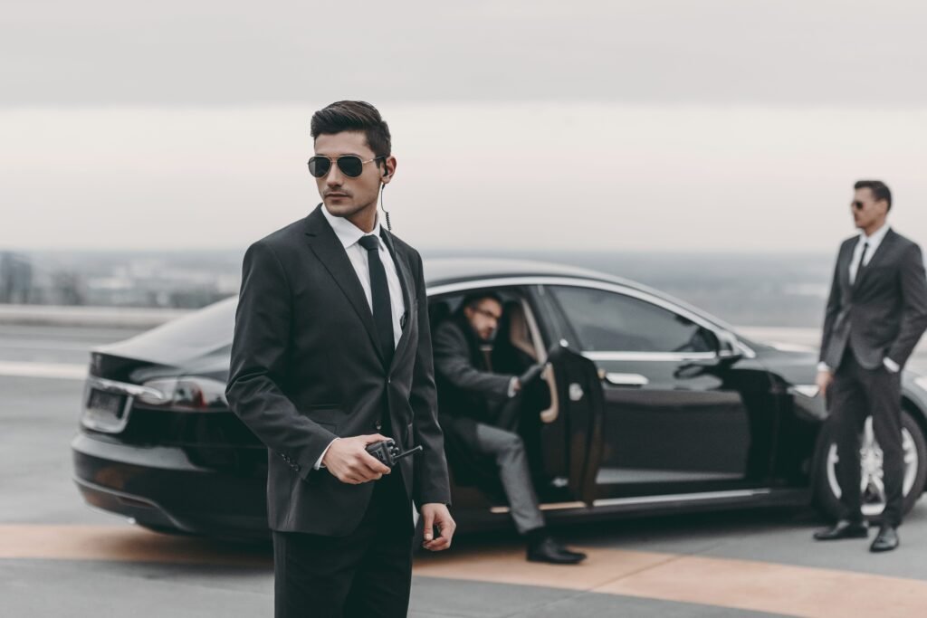 Body guard protecting person in the car.